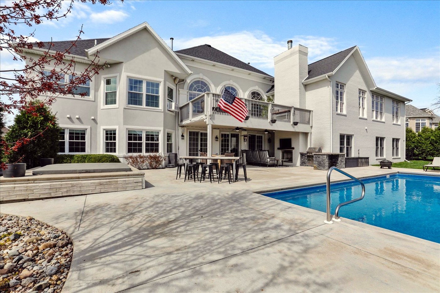 Longwood after renovation — rear elevation with patio, outdoor kitchen and pool